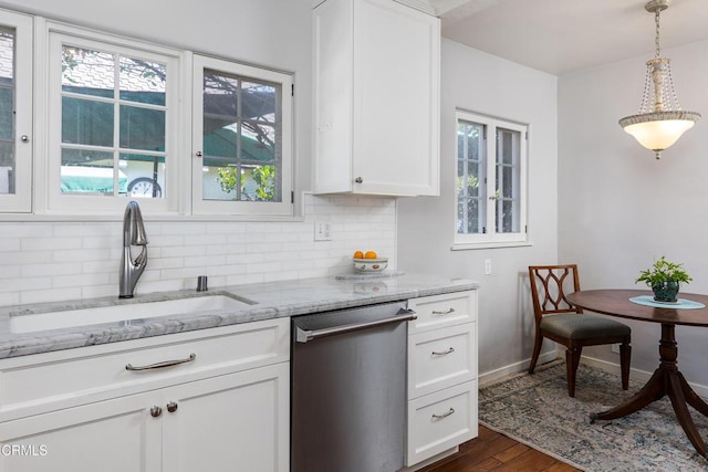 kitchen featuring decorative light fixtures, dishwasher, white cabinets, and sink