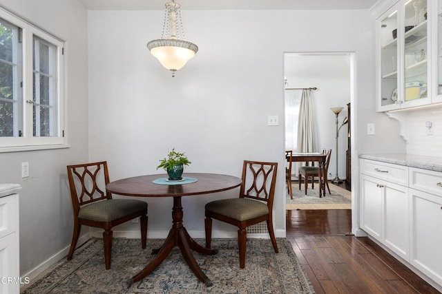 dining area with dark hardwood / wood-style flooring