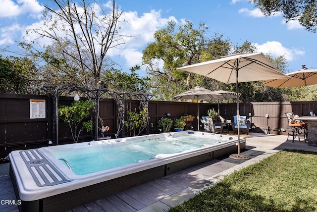 view of swimming pool featuring a wooden deck