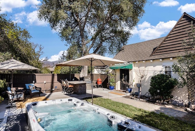 view of swimming pool featuring a hot tub and a patio