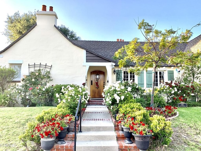 doorway to property with a lawn