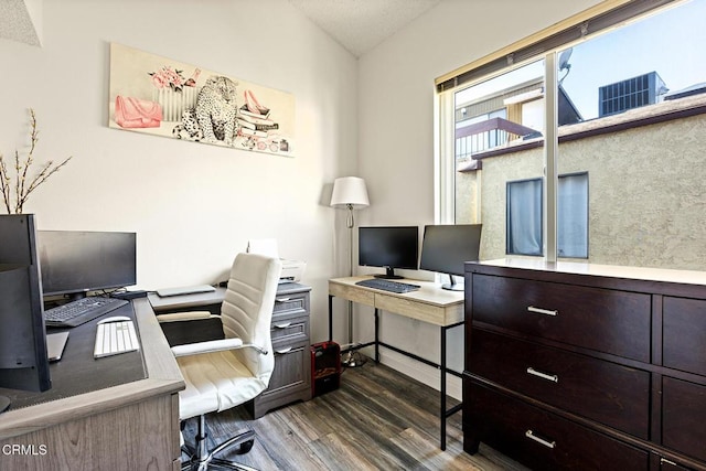 home office featuring vaulted ceiling and dark wood-type flooring