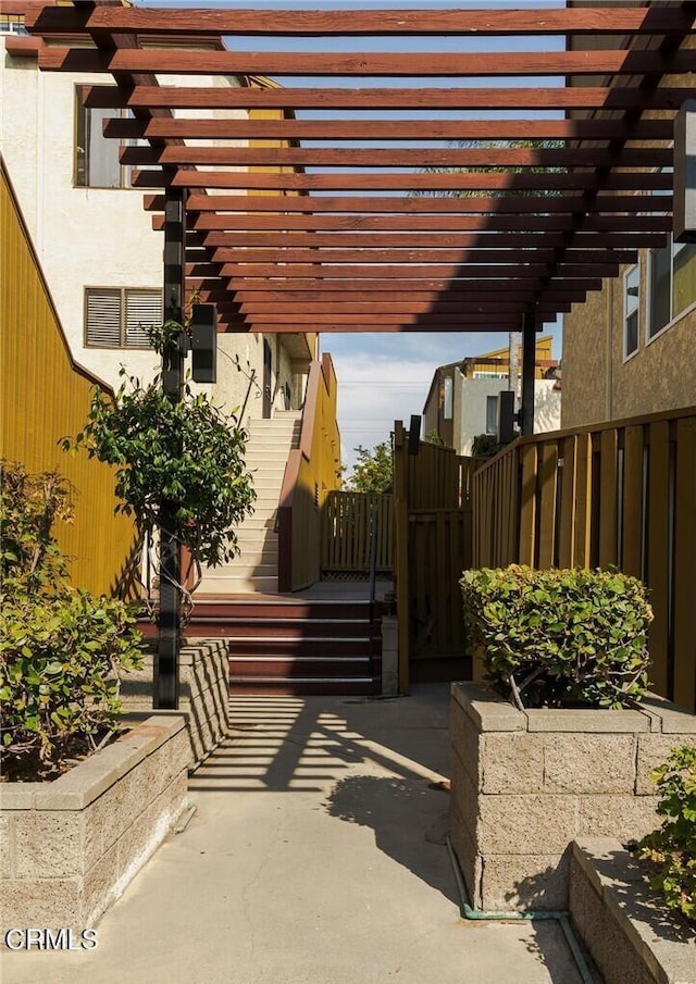 view of patio featuring a pergola and fence