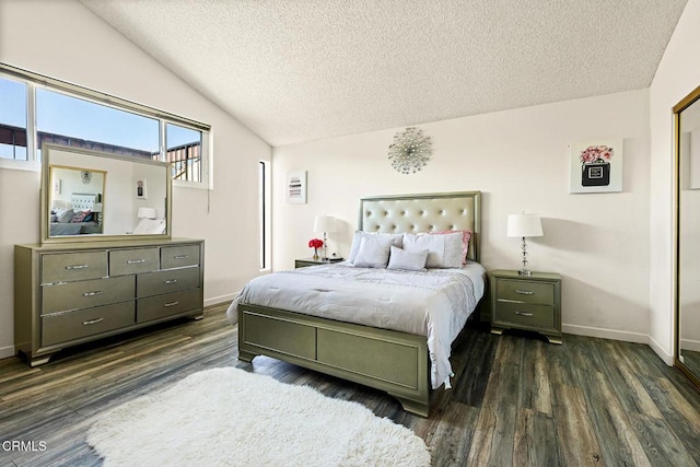bedroom with a textured ceiling, dark wood-style flooring, baseboards, and vaulted ceiling