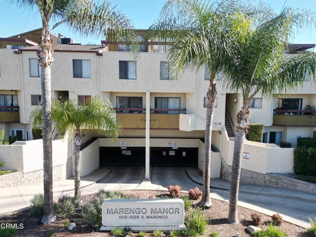 view of property featuring an attached garage and driveway