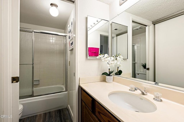1014 S Marengo Ave Unit 3, Alhambra, CA 91803 - full bath featuring toilet, wood finished floors, vanity, a textured ceiling, and shower / bath combination with glass door