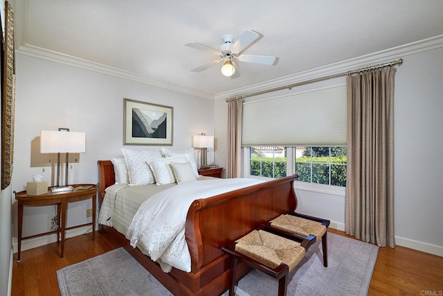 bedroom featuring ceiling fan, ornamental molding, and hardwood / wood-style flooring