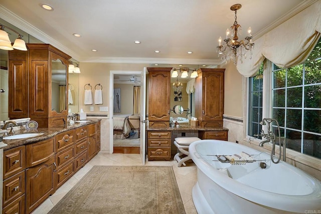 bathroom featuring a tub to relax in, vanity, tile patterned floors, and ornamental molding