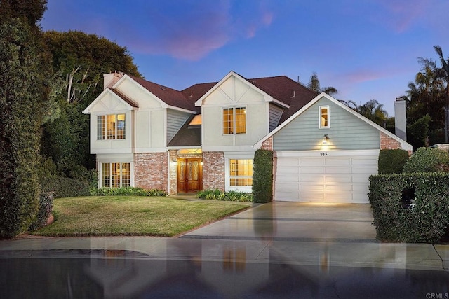 view of front of house with a garage and a lawn