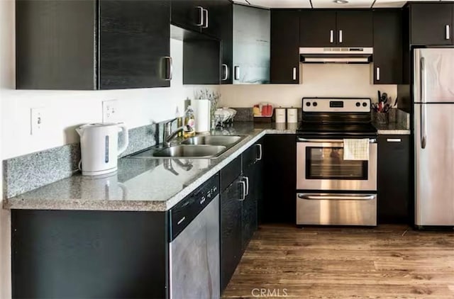 kitchen featuring sink, hardwood / wood-style flooring, and appliances with stainless steel finishes