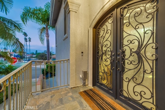 exterior entry at dusk with a balcony