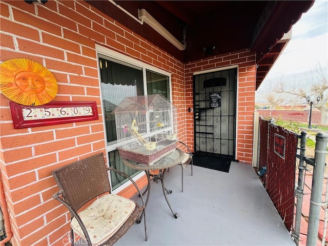 view of exterior entry featuring brick siding