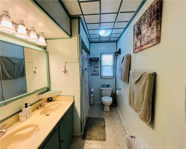 full bath featuring a sink, toilet, and double vanity