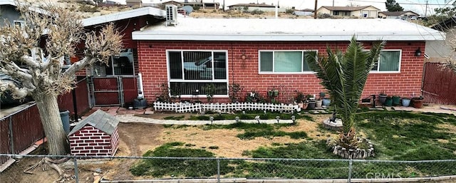 bungalow-style house with fence private yard and brick siding