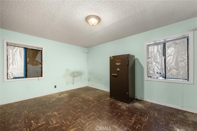 unfurnished room featuring a textured ceiling