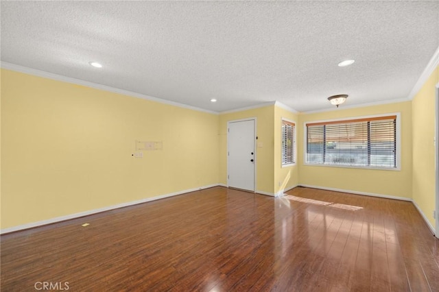 unfurnished room with hardwood / wood-style flooring, a textured ceiling, and ornamental molding