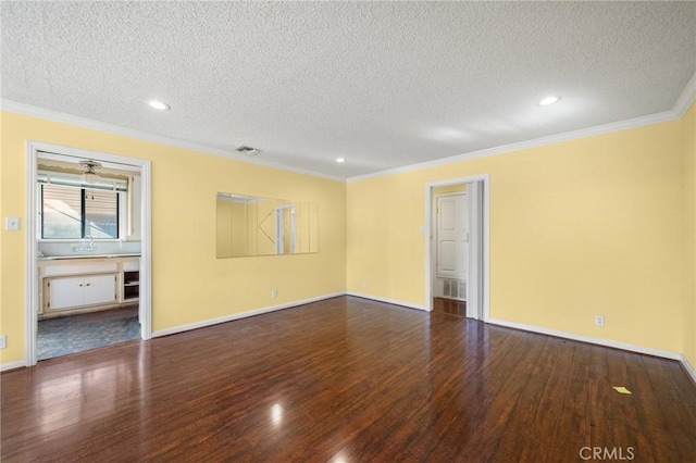 spare room featuring wood-type flooring, crown molding, and a textured ceiling