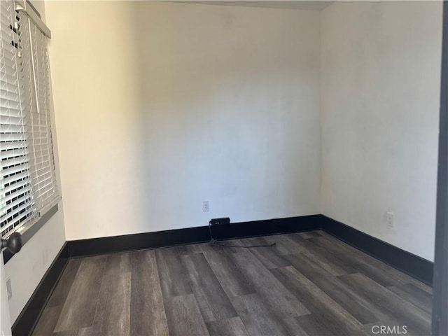 unfurnished room featuring dark hardwood / wood-style flooring