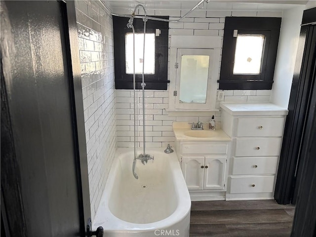 bathroom featuring bathing tub / shower combination, wood-type flooring, and vanity