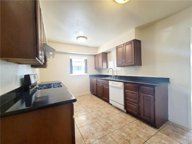 kitchen with sink, a textured ceiling, light tile patterned floors, and dishwasher