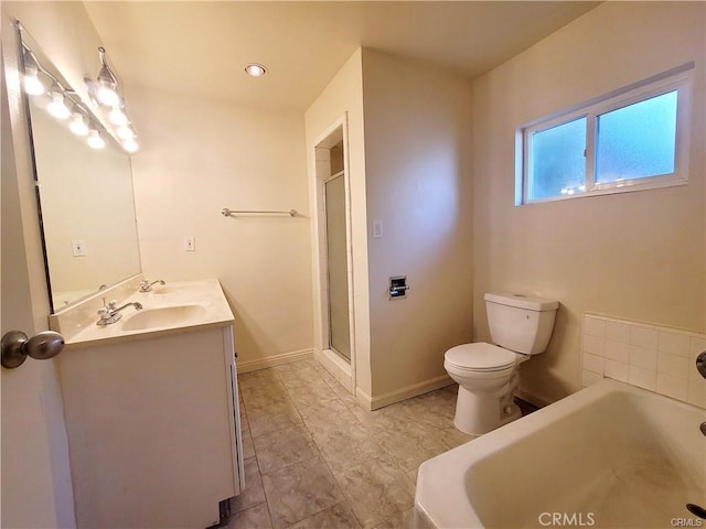 bathroom with toilet, vanity, and a tub to relax in