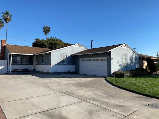 ranch-style home with a garage and a front yard