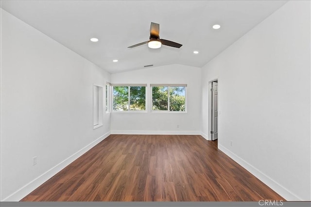 spare room featuring lofted ceiling, ceiling fan, and dark wood-type flooring