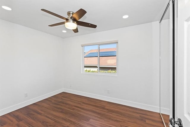 spare room with ceiling fan and dark hardwood / wood-style flooring