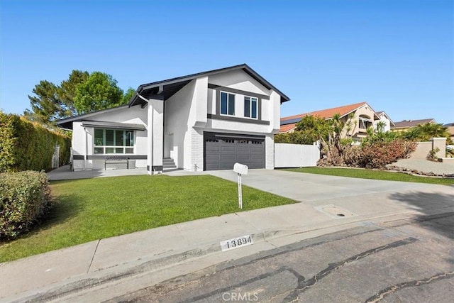 view of front of property featuring a front lawn and a garage