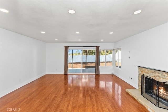 unfurnished living room with light wood-type flooring and a fireplace