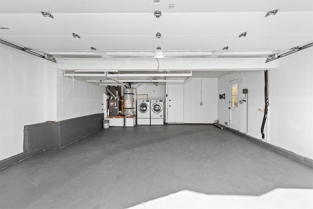 garage featuring water heater and washer and dryer