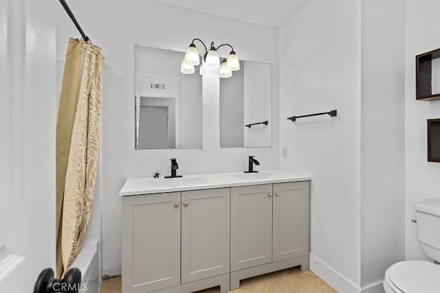 full bathroom with shower / bath combo with shower curtain, toilet, vanity, and tile patterned flooring