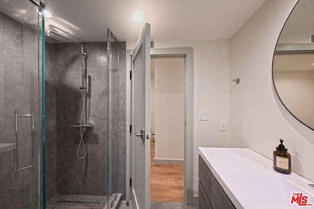 bathroom featuring an enclosed shower and vanity