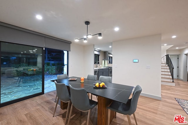 dining space featuring light hardwood / wood-style flooring and sink