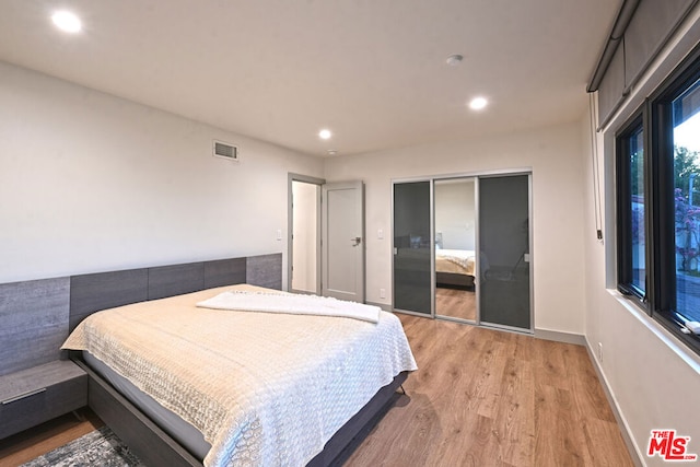 bedroom featuring a closet and light hardwood / wood-style flooring