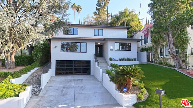 view of front of property with a front lawn and a garage