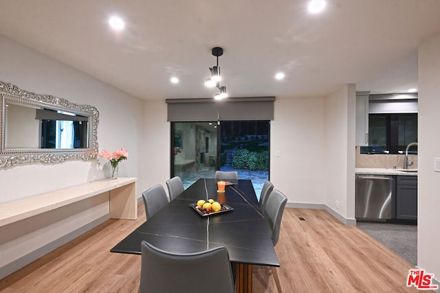 dining room with sink and light hardwood / wood-style flooring