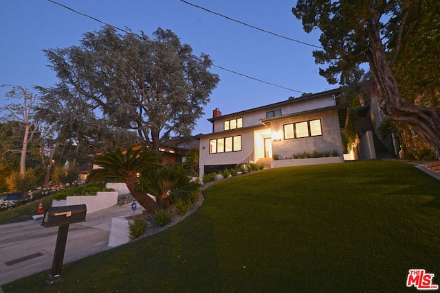 view of front of property with a yard and a patio