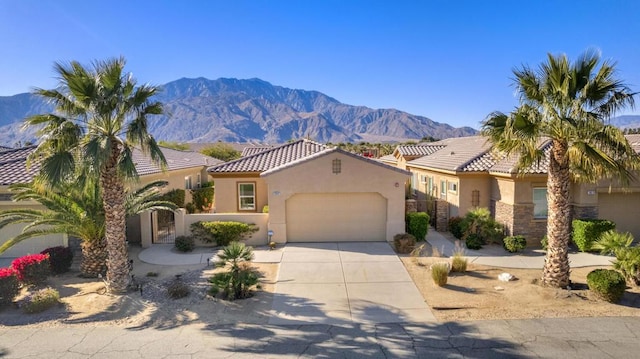 mediterranean / spanish home featuring a mountain view and a garage