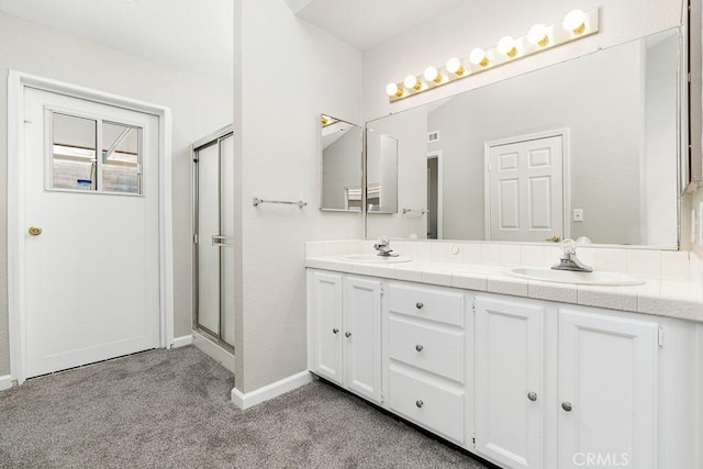 bathroom featuring walk in shower and vanity