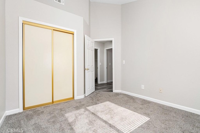 unfurnished bedroom featuring a closet and carpet flooring