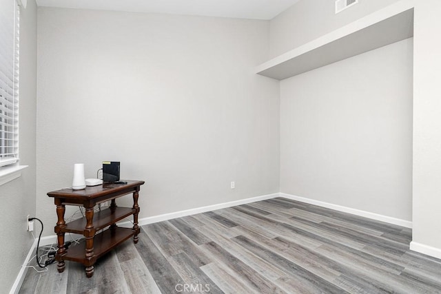 spare room with wood-type flooring