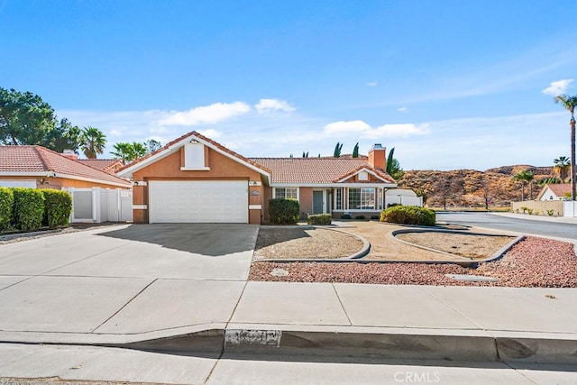 ranch-style home featuring a garage and a mountain view