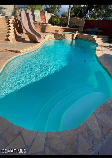 view of swimming pool featuring a water slide