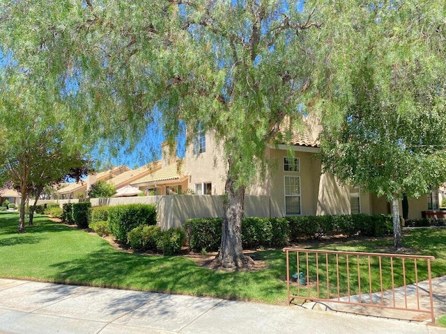 view of property exterior with a lawn