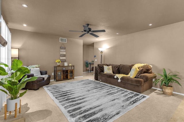 carpeted living room featuring ceiling fan