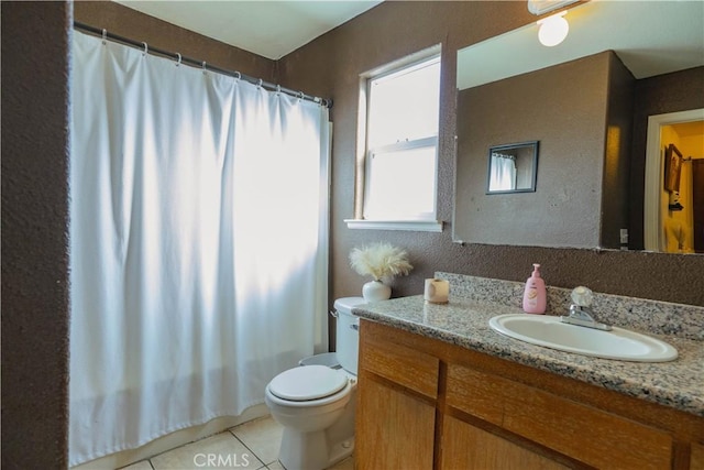 bathroom featuring toilet, vanity, a shower with curtain, and tile patterned flooring