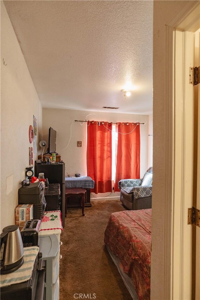 carpeted bedroom featuring a textured ceiling