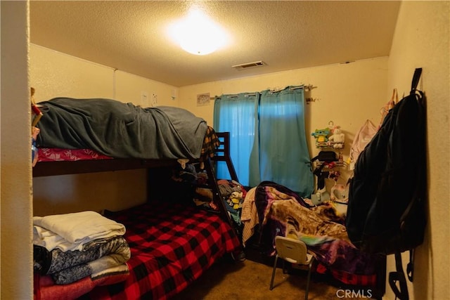 carpeted bedroom with a textured ceiling