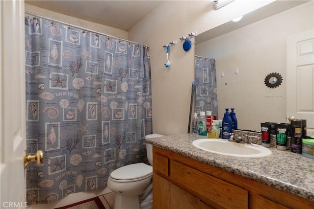 bathroom with toilet, tile patterned floors, vanity, and curtained shower